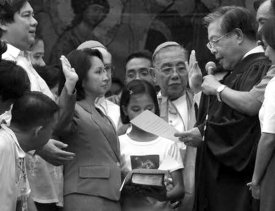 Then Vice President Gloria Macapagal-Arroyo being sworn into office, following the ouster  of President Joseph Estrada. Macapagal-Arroyo has blocked official interventions and civilian lobbying on artificial family planning such as the distribution of pills to women. With her in this photo is the late Jaime Cardinal Sin, a key player in the two People Power Revolutions. Photo from Tanikalang Ginto